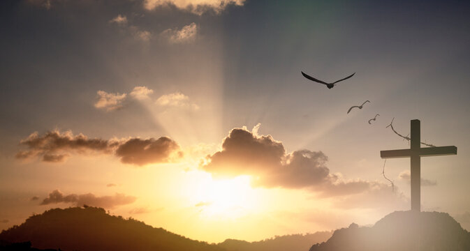 Silhouette of Jesus with Cross over sunset concept for religion, worship, Christmas, Easter, Redeemer Thanksgiving prayer and praise