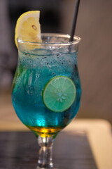 Blue Mocktail Mojito. A refreshing drink made from soda water, lime, basil seeds, and fruit syrup. cocktail with lime in glass. non alcohol mojito.