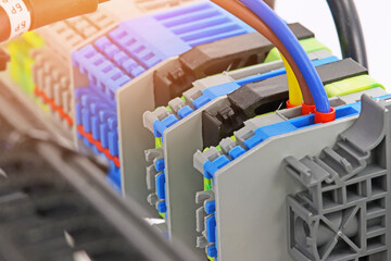 Fototapeta premium Electrical terminals with connected insulated copper wires with metal lugs. Marking with a thermal printer. 