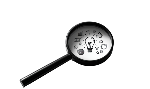 Magnifying glass focusing on a lightbulb and other business icons