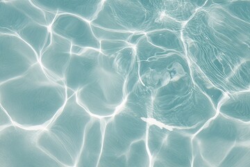 Light reflecting on rippled teal water surface