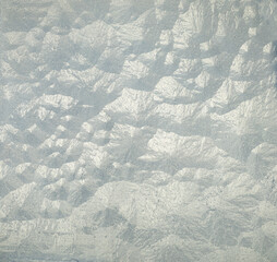 frozen window pane with pattern of ice crystals