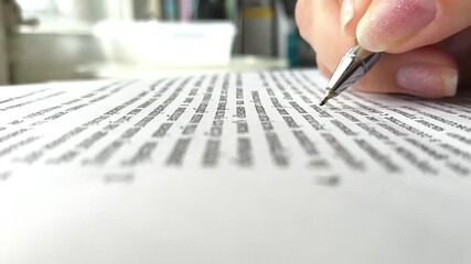 Businesswoman signing a document after reading the agreement in office - Powered by Adobe