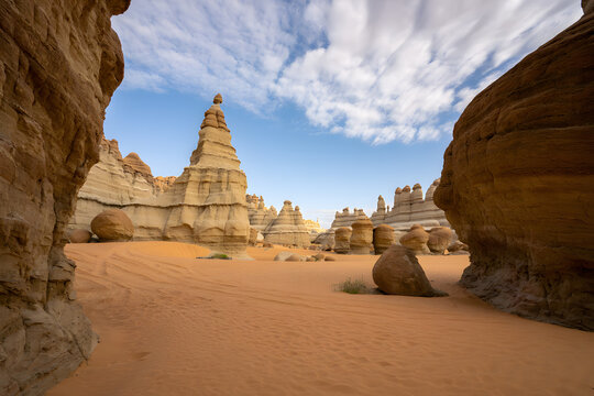 Desert hoodoos sandstone formations under blue sky with clouds rock formations geological