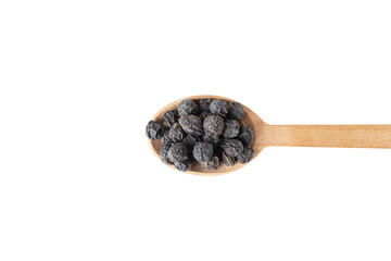 Dried Prunus spinosa, called blackthorn or sloe on wooden spoon isolated on white background.