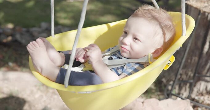 Cute Red Head Baby in Tree Bucket Style Baby Swing