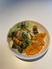 Fresh salad with grilled chicken and rice.