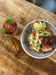 Colorful rice bowl with crispy fried chicken.