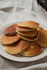 stack of pancakes on a plate homemade fluffy pancakes stack on white plate with linen napkin