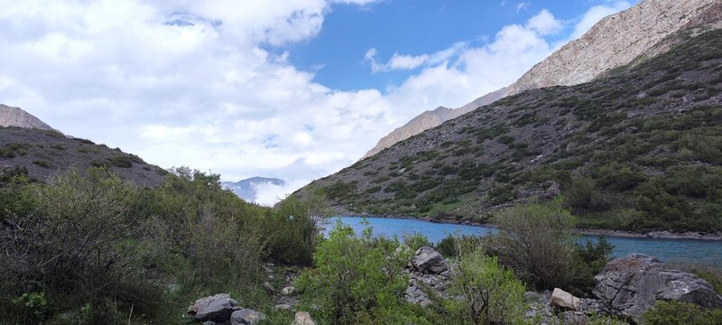 Clouds rise to the lake in the mountains of Sairam-Ugamsky National Park in the Republic of Kazakhstan, Shymkent, Sairam-Su gorge. At an altitude of 2350 meters above sea level.
