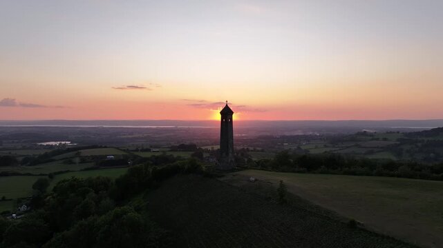 Aerial footage of the William Tyndale Monument at sunset in Dursley, in Gloucestershire, England, UK