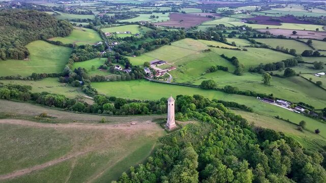 Orbiting aerial footage of the William Tyndale Monument at sunset in Gloucestershire, England, UK