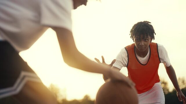 Skilled basketball training in nature, portrait of young black player in motion. Carefree african american children playing street ball, team training together, future champions of national league