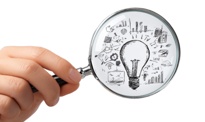 Hand holds magnifying glass focusing on sketched lightbulb & business ideas