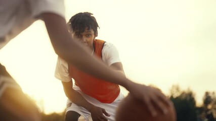 Sport for adolescents, african american teenagers playing basketball outdoors. Cinematic slow motion inside streetball match, young black players training together, exercise and practice for juniors - Powered by Adobe