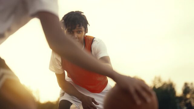Sport for adolescents, african american teenagers playing basketball outdoors. Cinematic slow motion inside streetball match, young black players training together, exercise and practice for juniors