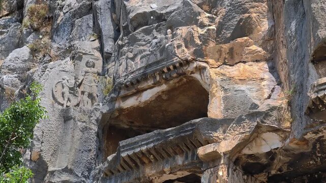 Rock-cut tombs of the ancient Lycian necropolis. Myra is an antique town in Lycia where the small town of Kale (Demre) Turkey. Close-up of rock cut tomb grave. 