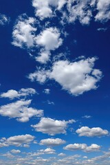 Fototapeta premium Vast blue sky dotted with puffy clouds