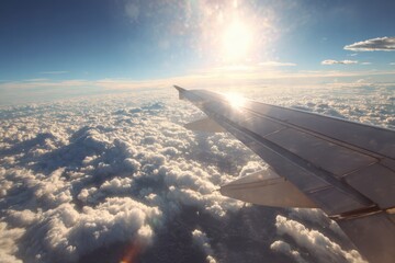 Obraz premium Aerial view of fluffy clouds beneath airplane wing during sunset, showcasing serene sky