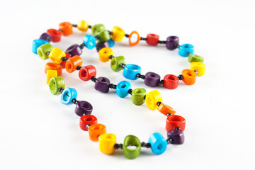A colorful beaded necklace made of bright, vibrant, and circular beads strung together with black thread.