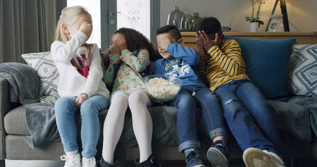 Popcorn, scared and watching tv with children on sofa in living room of home together for bonding....