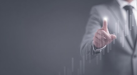Businessman pointing at a projected upward trend graph