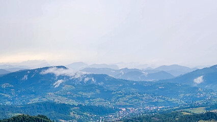 A tranquil scene of layered misty mountains and dense forests, perfect for travel promotions,...