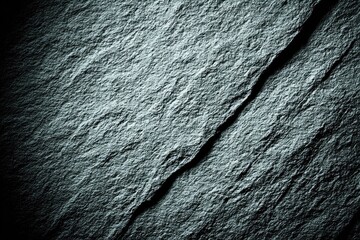 Close-up view of a textured stone surface with a diagonal crack