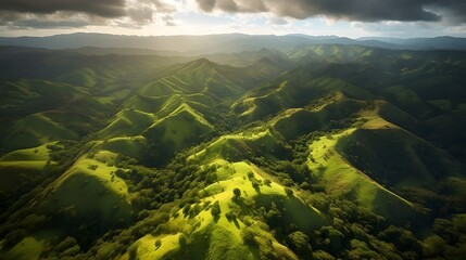 Golden hour over rolling hills with vibrant green fields and deep shadows, aerial perspective showcasing the tranquil beauty of dusk in nature mountain landscape with clouds