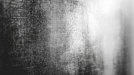 Close-up of textured fabric in monochrome, highlighting intricate weave patterns and shadows