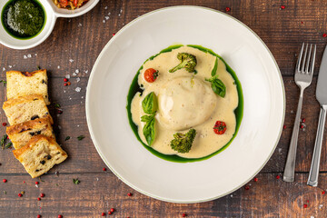 Gourmet stuffed pasta served with creamy sauce, broccoli and herbs