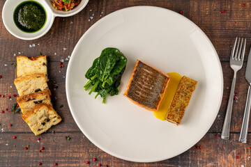 Seared salmon fillet served with wilted spinach and potato croquette
