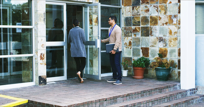 Walking, woman and man holding door for arrival at company, morning and travel to meeting. Open, colleague or friendly people with work, team and together for commute, gratitude and help or start