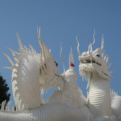 Wat Huay Pla Kang,Figures and houses at the giant white buddha in Chiang Rai, Thailand