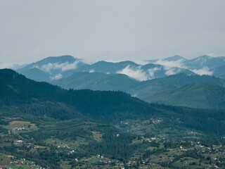 A sweeping view of green hills and distant mountains under a stormy sky, perfect for travel ads, nature documentaries, and eco-conscious branding