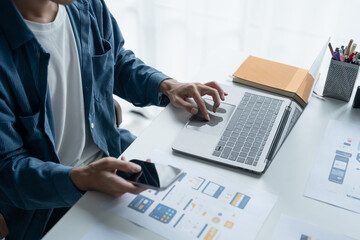 UX UI Designer Planning innovative Mobile App with Paper Wireframe Designs at Workspace.