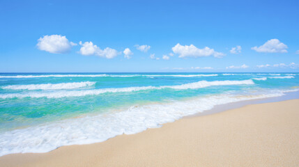 Golden sandy beach under a clear blue sky with gentle waves lapping at the shore