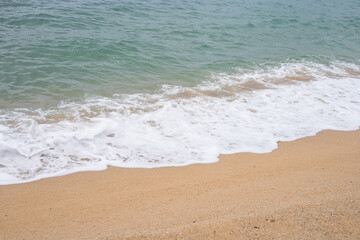 Serene ocean waves lapping at sandy beach shoreline