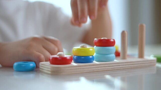 Child solving puzzle to develop numeracy skills. Focused kid playing puzzle pieces. Educational puzzle boosts child numeracy and learning. Fun indoor activity enhances child cognitive development.