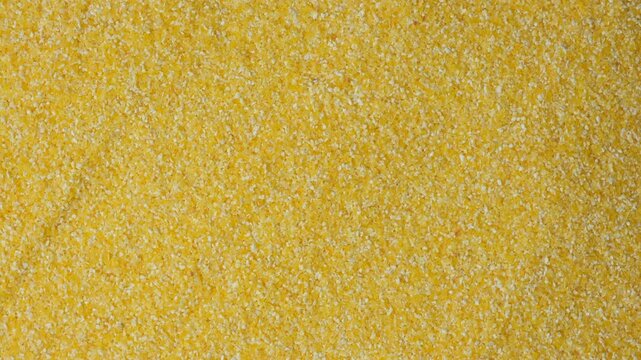 Raw Yellow Corn Grits Close-Up Texture Top View