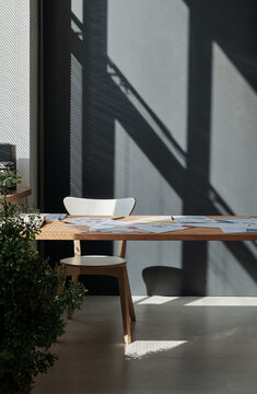 Vertical image of empty workplace of office worker with documents on it with plants at office