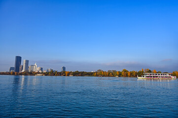 Fototapeta premium Panorama of Vienna with tourist ship on Danube river , Austria,autumn season