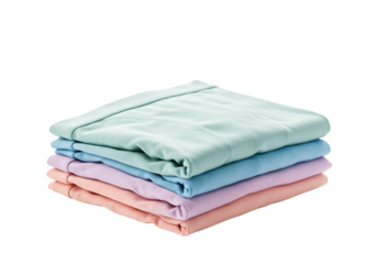 Stack of neatly folded pastel-colored cotton and linen bed sheets on black background