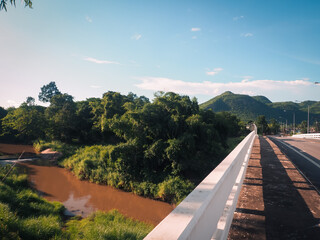 Mountain view and bridge over the river, fresh natural rainy season atmosphere