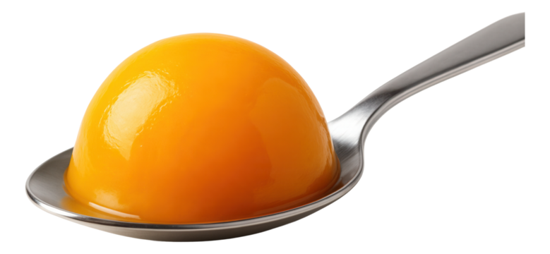 A smooth dome of mango gel, perfectly centered on a stainless steel spoon.