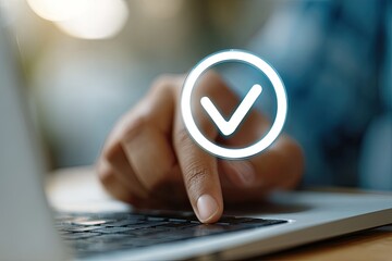A hand hovering over a laptop keyboard with a glowing check mark overlay