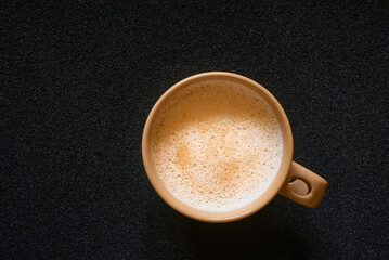 top view coffee cup with cappuccino latte foam on black background