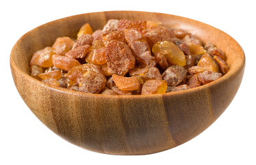 Crushed amber in the wooden bowl, isolated on white background.