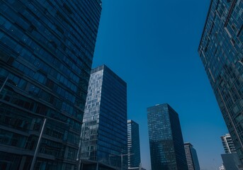 Obraz premium Modern Skyscrapers Against a Clear Blue Sky Urban Architecture and Cityscape, Business, Commercial Buildings.