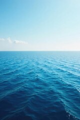 Obraz premium Vast, tranquil ocean stretching to the hazy horizon under a clear sky Perfect for travel, nature, or serenity themes Captures the immensity and peace of the open sea , waves, clear